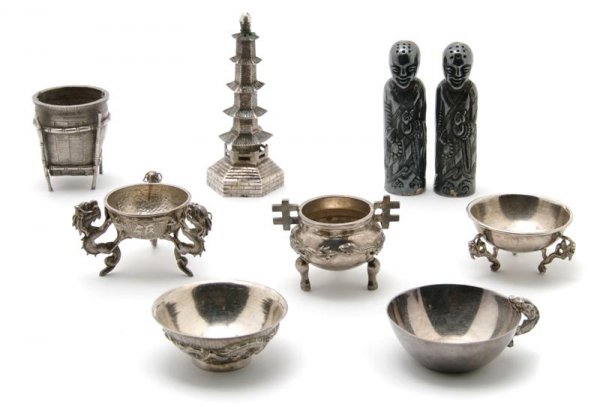 A Collection of Nine Chinese Silver Articles, Hei: A Collection of Nine Chinese Silver Articles, comprising a pagoda, five small salt cellars in the form of archaic Chinese vessels and a figural salt and pepper. Height of tallest 3 1/2 inches.