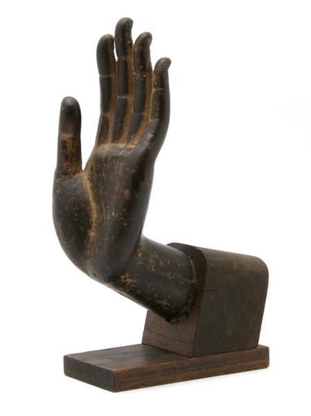 A Southeast Asian Painted Terracotta Model of the: A Southeast Asian Painted Terracotta Model of the Hand of Buddha, raised on fitted wood base. Height 9 1/4 inches.