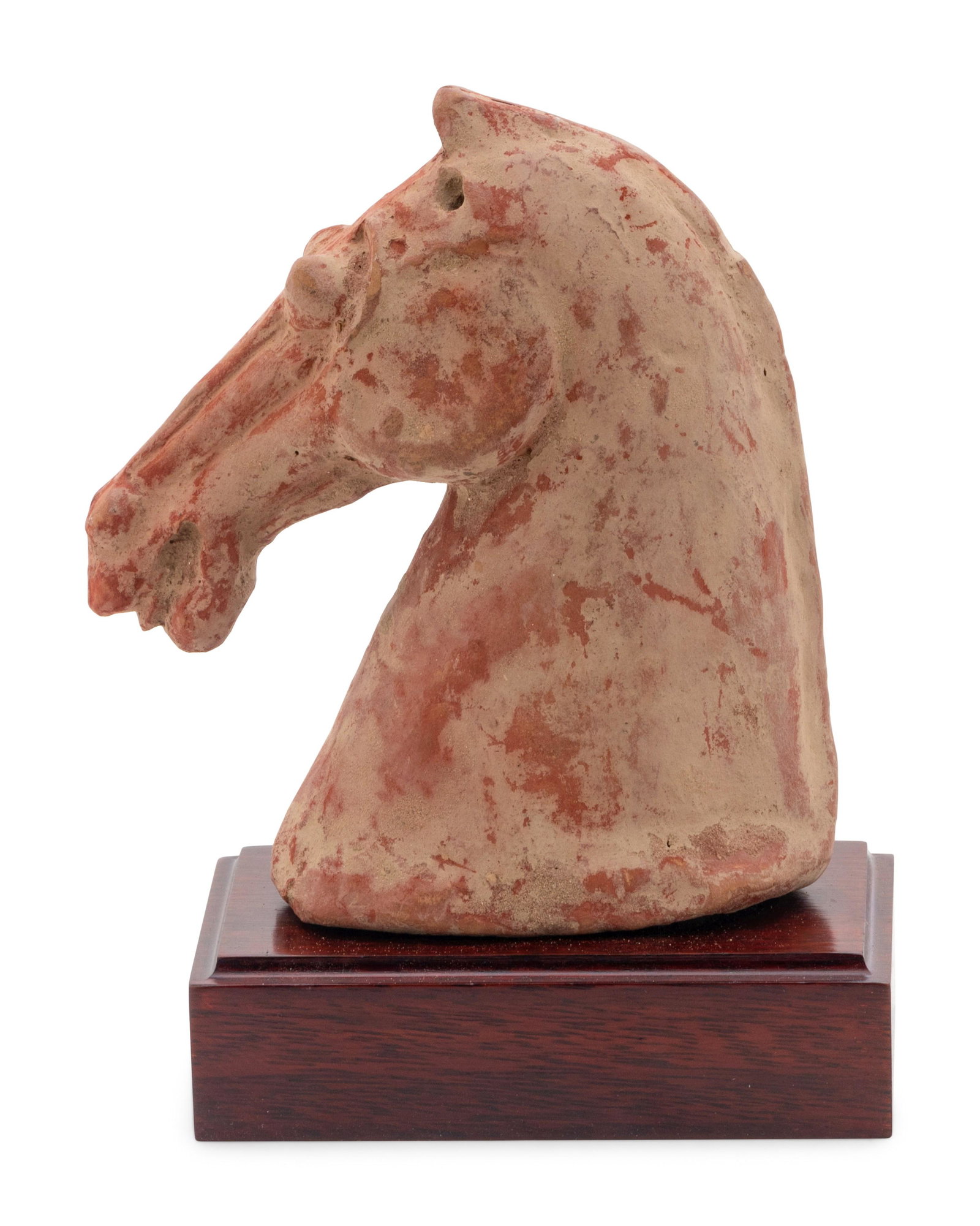 A Chinese Red Pottery Head of a Horse: A Chinese Red Pottery Head of a Horse HAN DYNASTY (206 B.C.-220 A.D.) boldly molded with protruding eyes, raised above a conforming carved hardwood stand. Height 6 1/2 in., 16.5 cm. Property from the 
