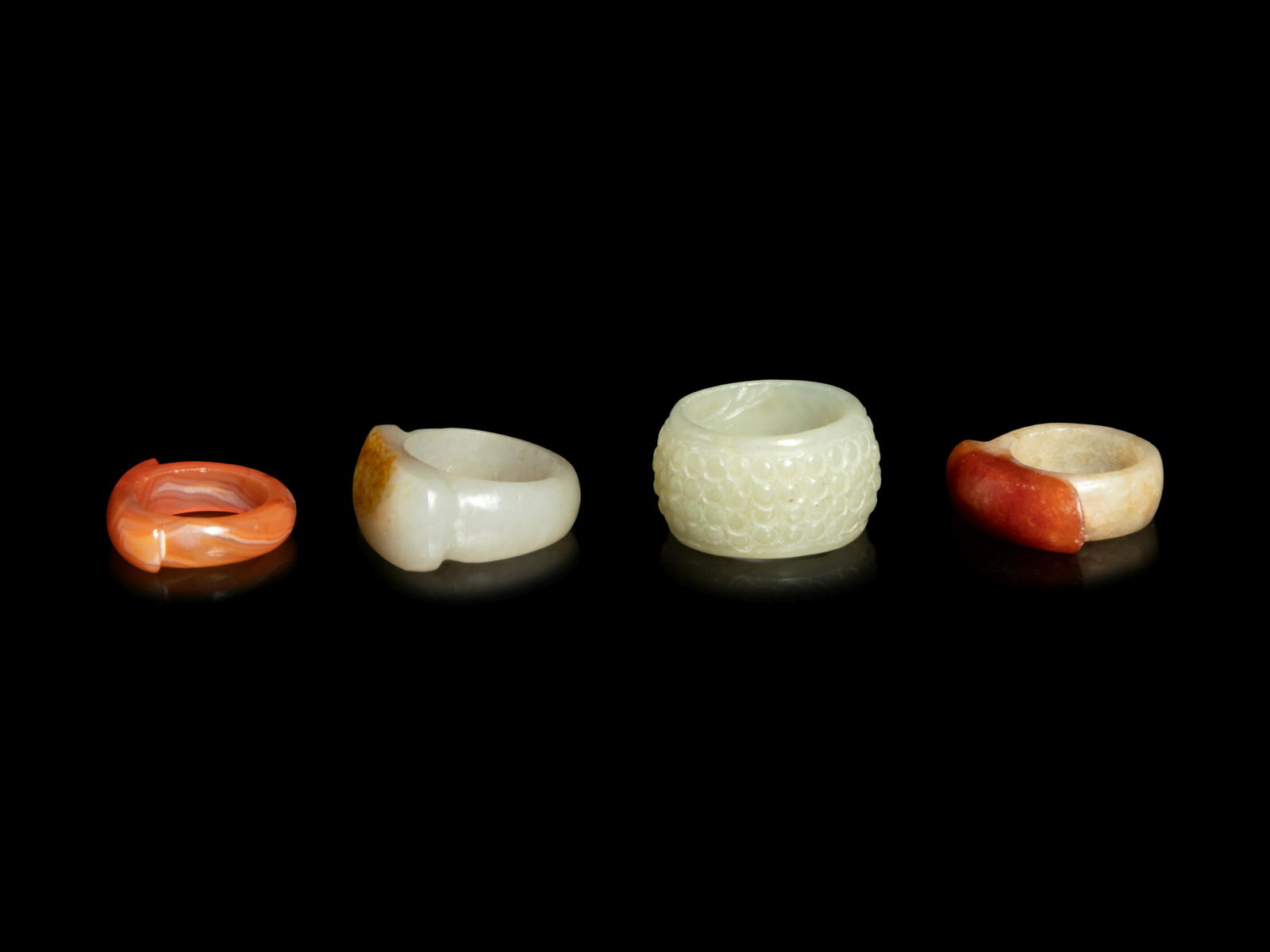 Four Chinese Jade and Hardstone Archer's Rings (1 of 3)