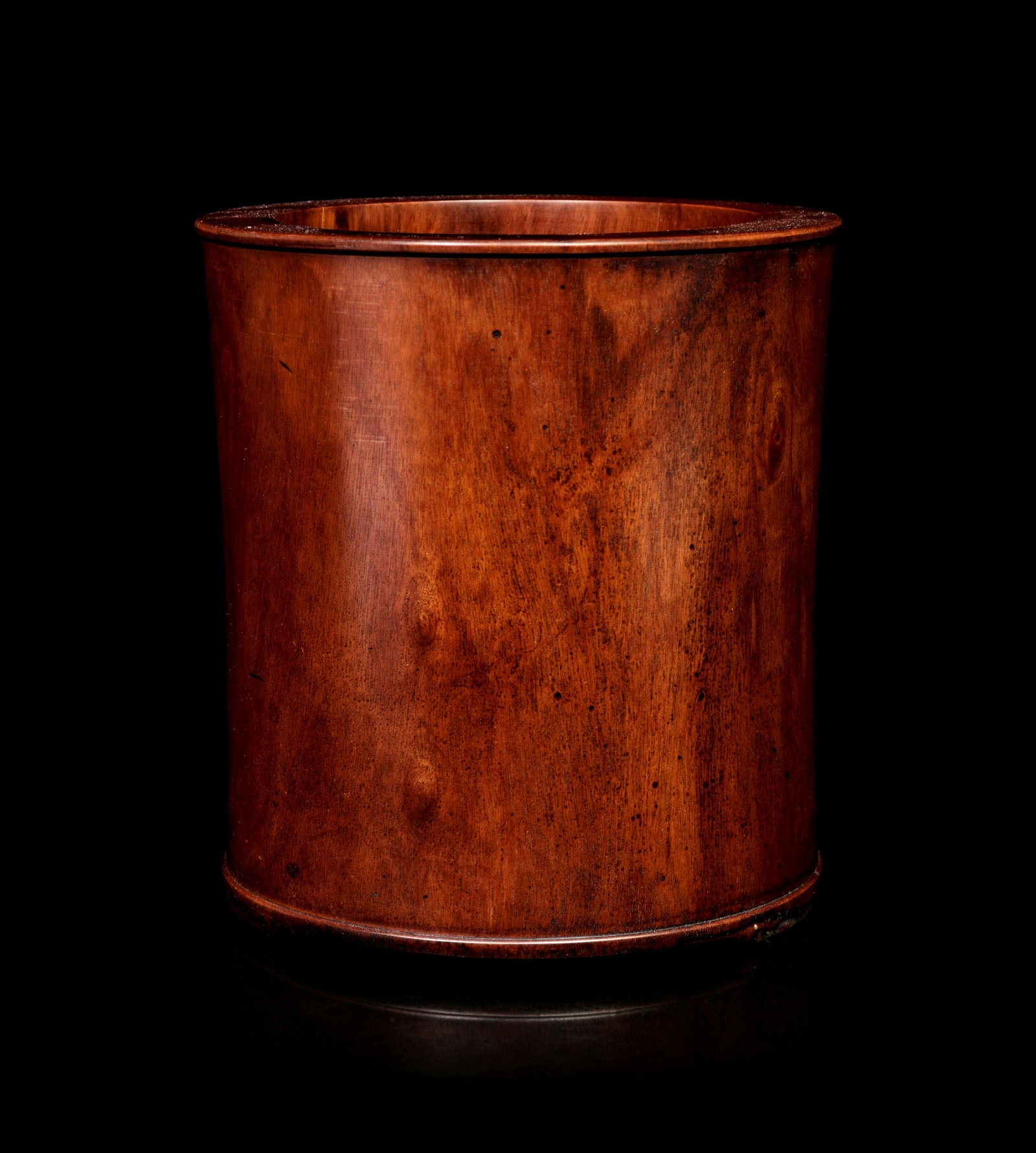 A Chinese Huanghuali Brush Pot: A Chinese Huanghuali Brush Pot of slightly waisted cylindrical form, with a brownish patina. Height 6 1/2 in., 16.5 cm.
