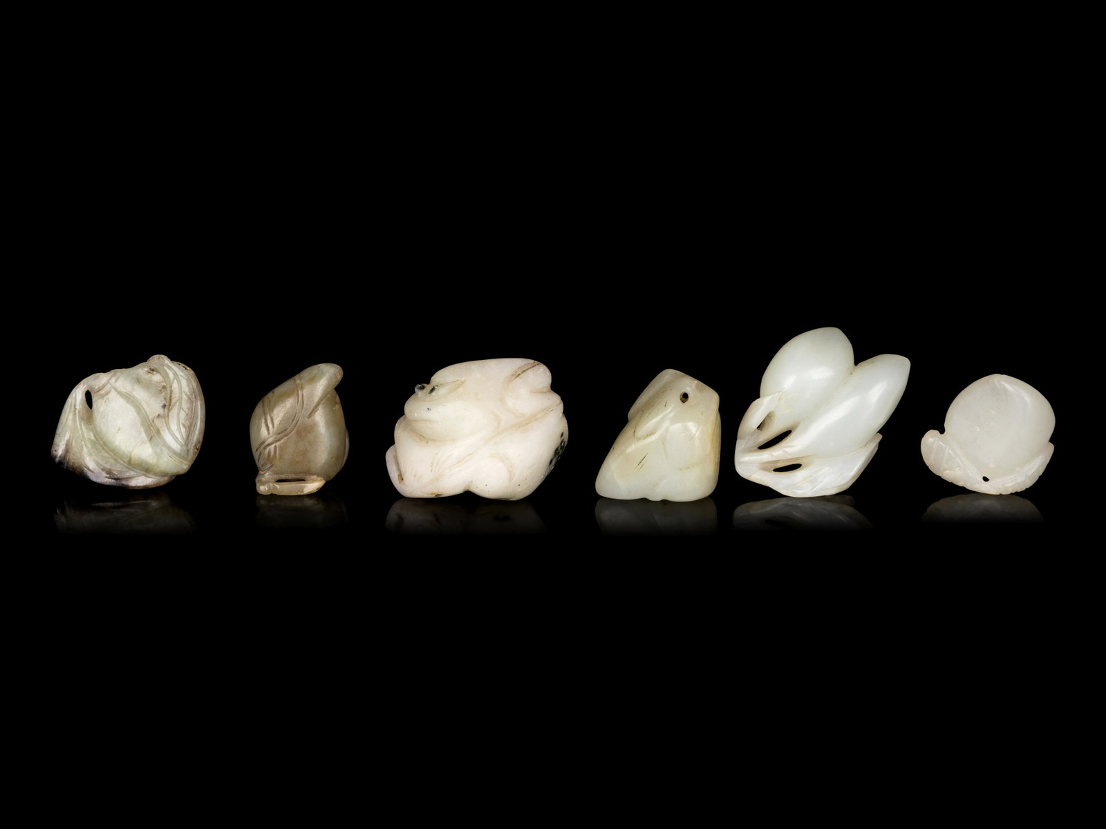 Six Chinese Celadon Jade Carvings of Peaches: Six Chinese Celadon Jade Carvings of Peaches each softly polished to show a plumb fruit borne of incised and reticulated leaves, softly polished. Height of tallest 1 3/4 in., 4.2 cm. Property from a P