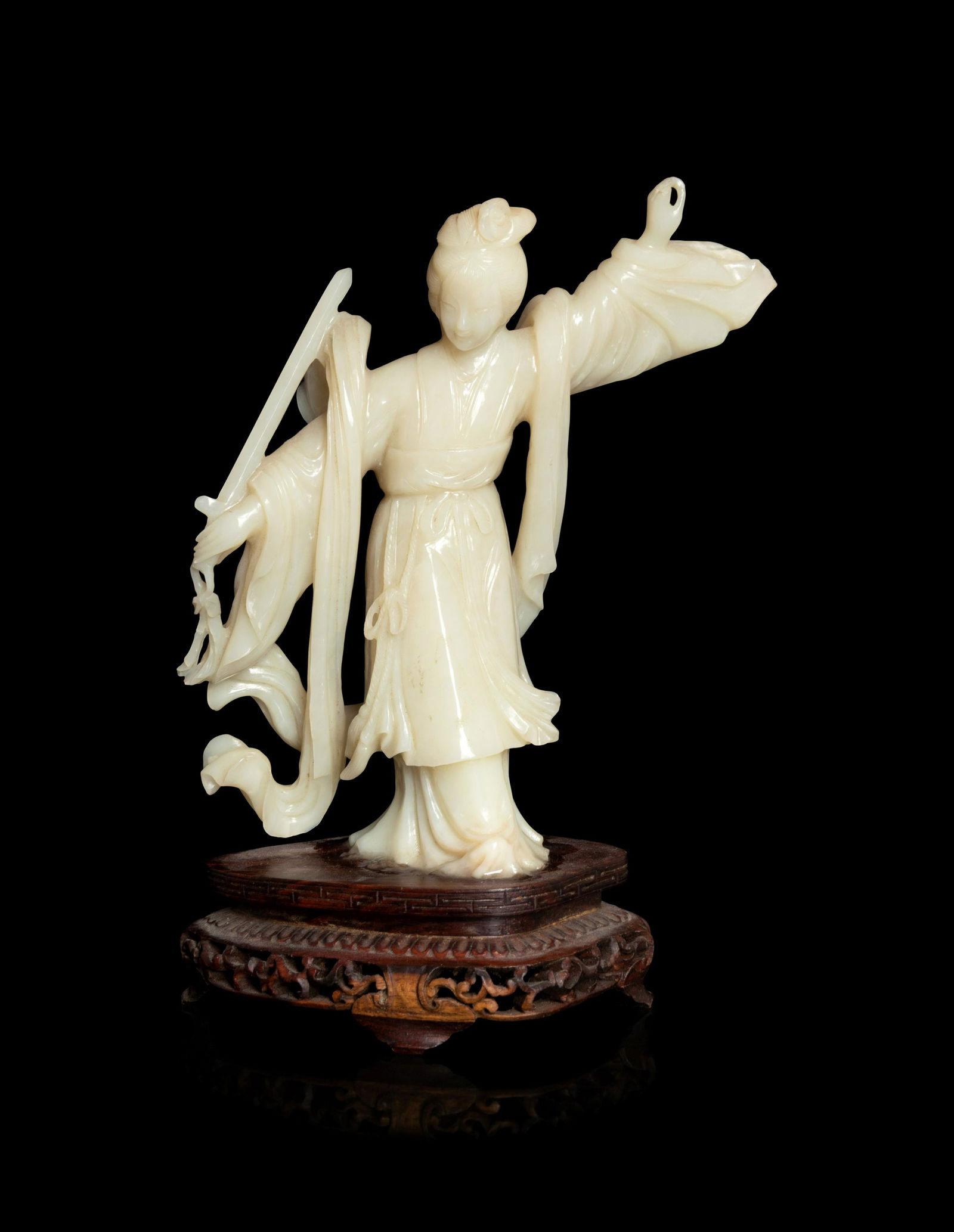 A Chinese Jade Figure of a Female Immortal: A Chinese Jade Figure of a Female Immortal 20TH CENTURY 二十世紀 青玉雕仕女立像 adorned in flowing robes cinched at the waist and stan