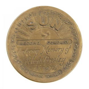 An Elvis Presley Commemorative Sun Records Belt Buck: An Elvis Presley Commemorative Sun Records Belt Buckle, on the front it reads, "In Loving Memory of Elvis Presley 1935 - 1977," marked "private edition," with the Sun Records logo stamped to the back.