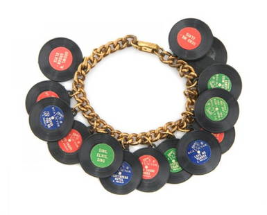 An Elvis Presley Plastic Record Charm Bracelet,: An Elvis Presley Plastic Record Charm Bracelet, featuring 14 plastic records of Elvis Presley's greatest hits, with two detached but present.