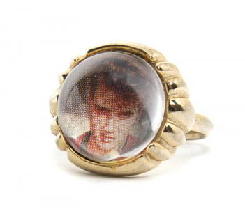 An Elvis Presley Enterprises Adjustable Photo Ring,: An Elvis Presley Enterprises Adjustable Photo Ring, with a color photograph of Elvis Presley underneath a clear composite cabochon covering, licensed 1956, stamped "Elvis Presley Enterprises - All