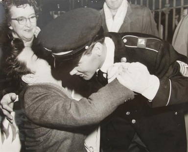 A Signed Photograph and Negative of Elvis Presley i: A Signed Photograph and Negative of Elvis Presley in Uniform Hugging Gary Pepper, black and white, 8 x 10 inches, depicting Elvis Presley hugging Gary Pepper upon his return from the Army, inscribed