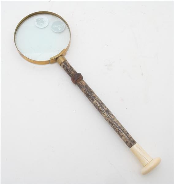 An English Shagreen Covered Magnifying Glass, Leng: An English Shagreen Covered Magnifying Glass, the brass mounted lens above a shagreen covered handle terminating in an ivory knob. Length 13 1/2 inches.