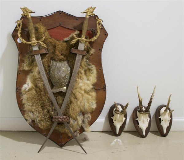 A Steel, Brass and Pelt Trophy, Height of largest : A Steel, Brass and Pelt Trophy, of shield form together with three bone and horn mounts. Height of largest 26 1/2 inches.