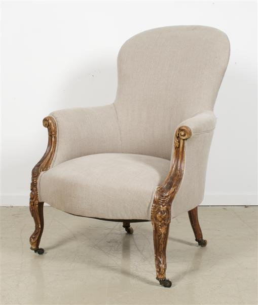 A Louis XV Style Bergere, Height 39 inches.: A Louis XV Style Bergere, having upholstered back arms and seat, raised on carved cabriole legs ending in castors. Height 39 inches.