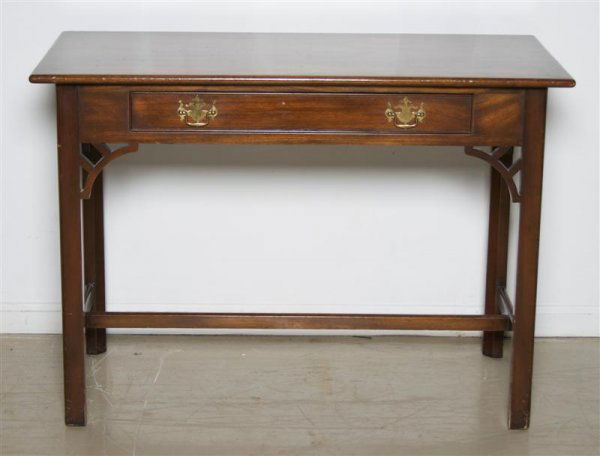 An American Mahogany Writing Desk, Kittinger, Heig: An American Mahogany Writing Desk, Kittinger, having a rectangular top over single drawer, raised on square legs joined by stretcher. Height 30 x width 24 x depth 21 inches.