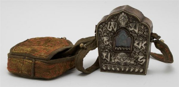A Southeast Asian Traveling Shrine, Height 5 inche: A Southeast Asian Traveling Shrine, having tolled silver metal case with copper back, the front having a small window with figure of Buddha contained inside, having cloth case with strap. Height 5 inc