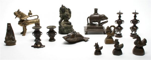 A Collection of Fourteen Southeast Asian Bronze I: A Collection of Fourteen Southeast Asian Bronze Items, comprised of miniature pricket sticks, scroll weights, figural items and a lobster form water dropper. Height of tallest 5 inches. Property from 