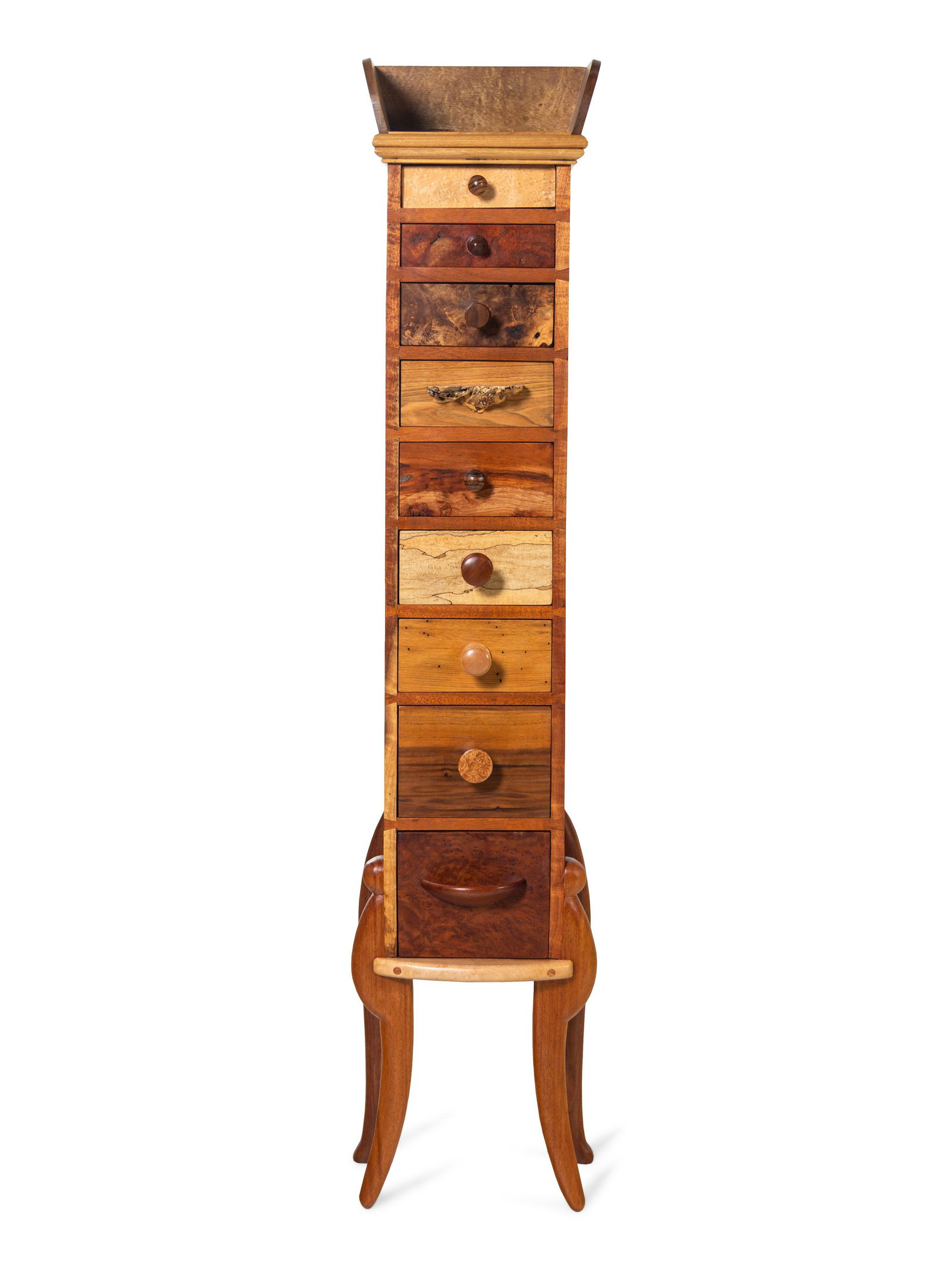 Tommy Simpson (American, b. 1939) Tall Chest of Drawers: Tommy Simpson (American, b. 1939) Tall Chest of Drawers mixed woods, metal knobs signed H 55 x W 11 1/2 x D 10 inches. Property from the Collection of Dr. Robert C. Springborn and Mrs. Carolyn J. Spri