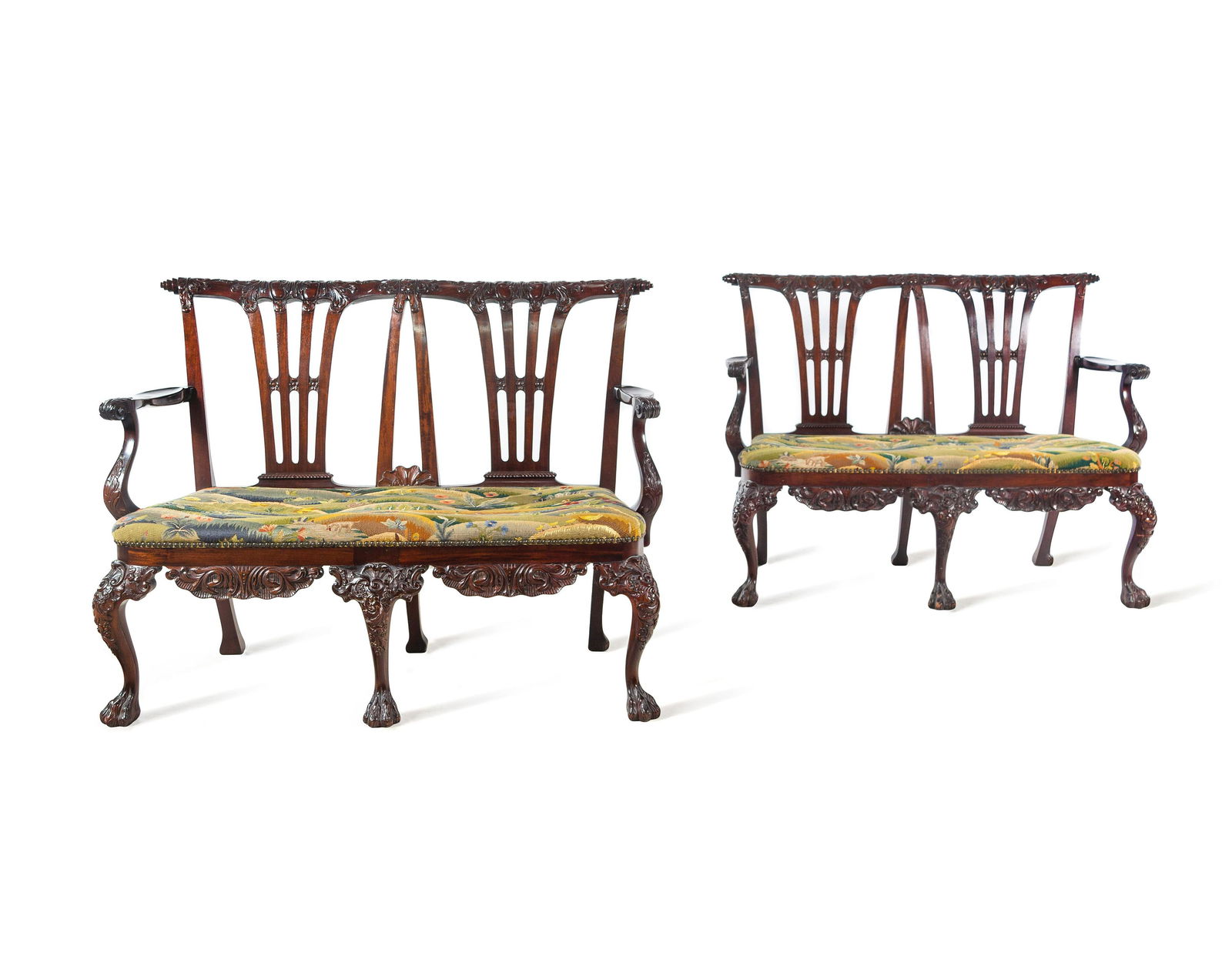 A Pair of Irish George II Style Carved Mahogany: A Pair of Irish George II Style Carved Mahogany Double-Back Settees Late 19th/Early 20th Century Height 38 x width 49 x depth 28 inches. Provenance: By repute, Collection of Pansy Yount at Spindletop