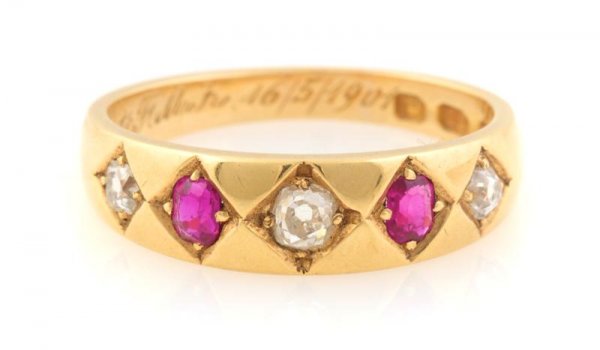 A Victorian 18 Karat Yellow Gold, Ruby and Diamond: A Victorian 18 Karat Yellow Gold, Ruby and Diamond Ring, Circa 1877, containing three old mine cut diamonds weighing approximately 0.15 carat total and two cushion cut rubies weighing approximately 0.