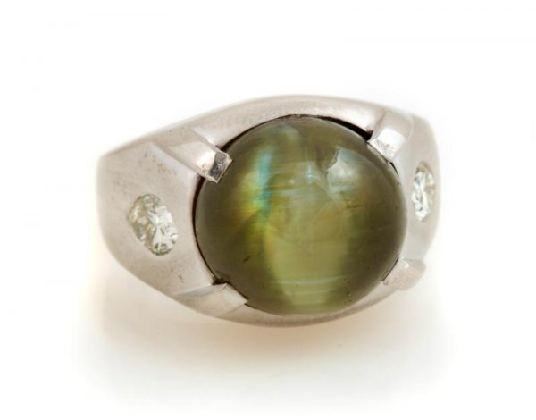 A 14 Karat White Gold, Cat's Eye Chrysoberyl and D: A 14 Karat White Gold, Cat's Eye Chrysoberyl and Diamond Ring, containing one oval cat's eye chrysoberyl weighing approximately 17.00 carats and two marquise shape diamonds weighing approximately 0.80