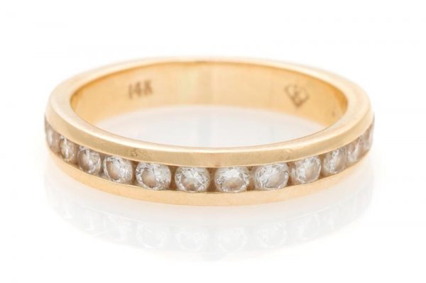 A 14 Karat Yellow Gold and Diamond Eternity Band,