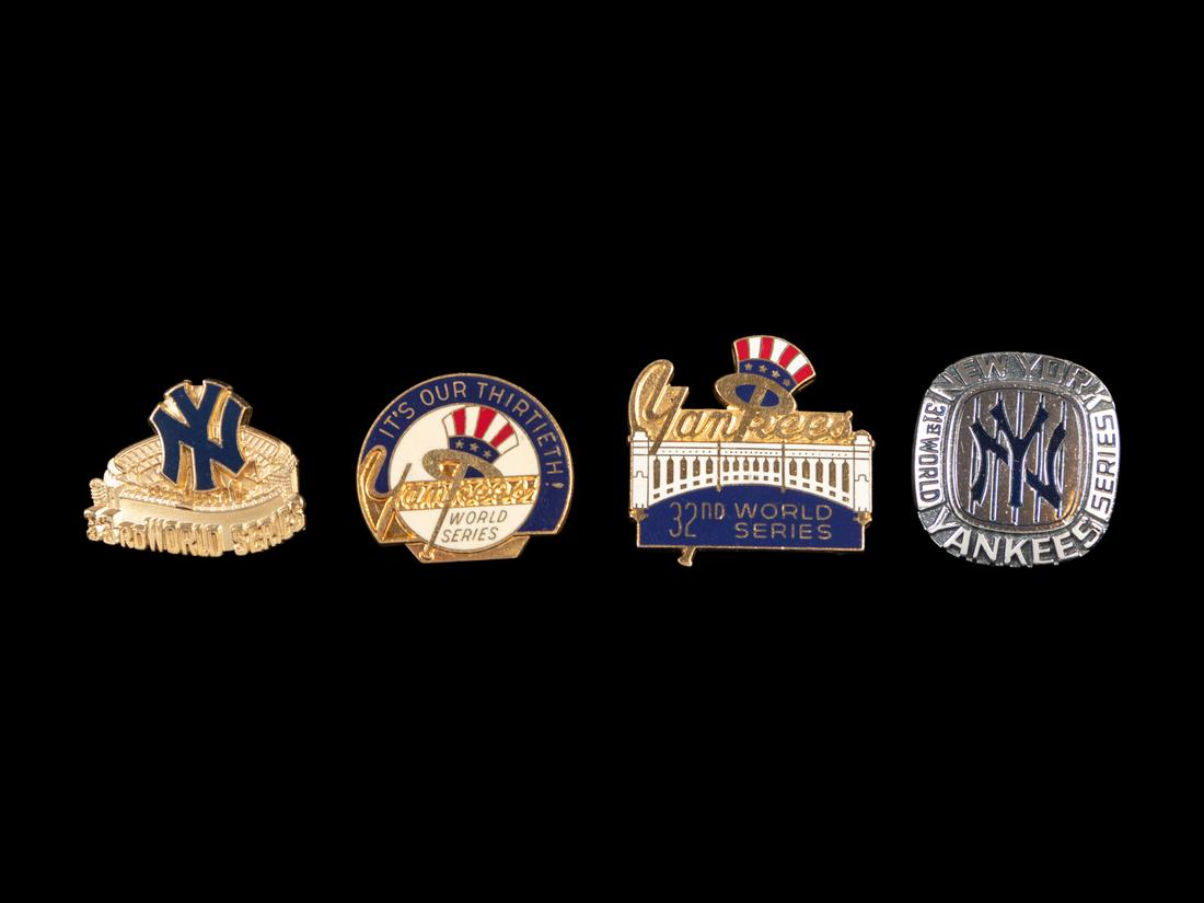 A Group of Four 1970s - 1980s New York Yankees World: A Group of Four 1970s - 1980s New York Yankees World Series Yankee Stadium Press Pins, comprising of original Balfour manufactured Yankees Stadium issues from 1976 (vs. Cincinnati Reds), 1977 (vs. Los