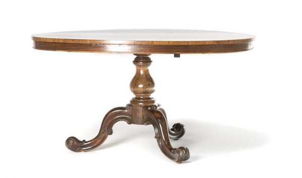 An English Regency Tilt-Top Breakfast Table, Height: An English Regency Tilt-Top Breakfast Table, having an oval top, over turned baluster form stems, raised on three cabriole foliate top legs. Height 28 x width 52 x depth 39 1/2 inches.