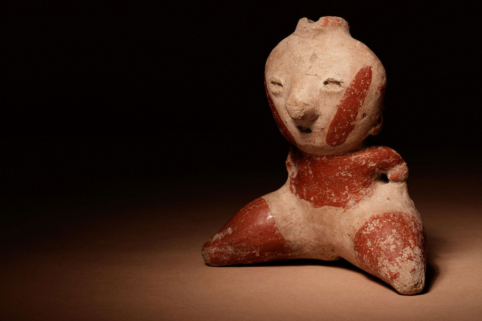 A Nayarit Terracotta Seated Figure Height 4 1/2 x width (1 of 3)