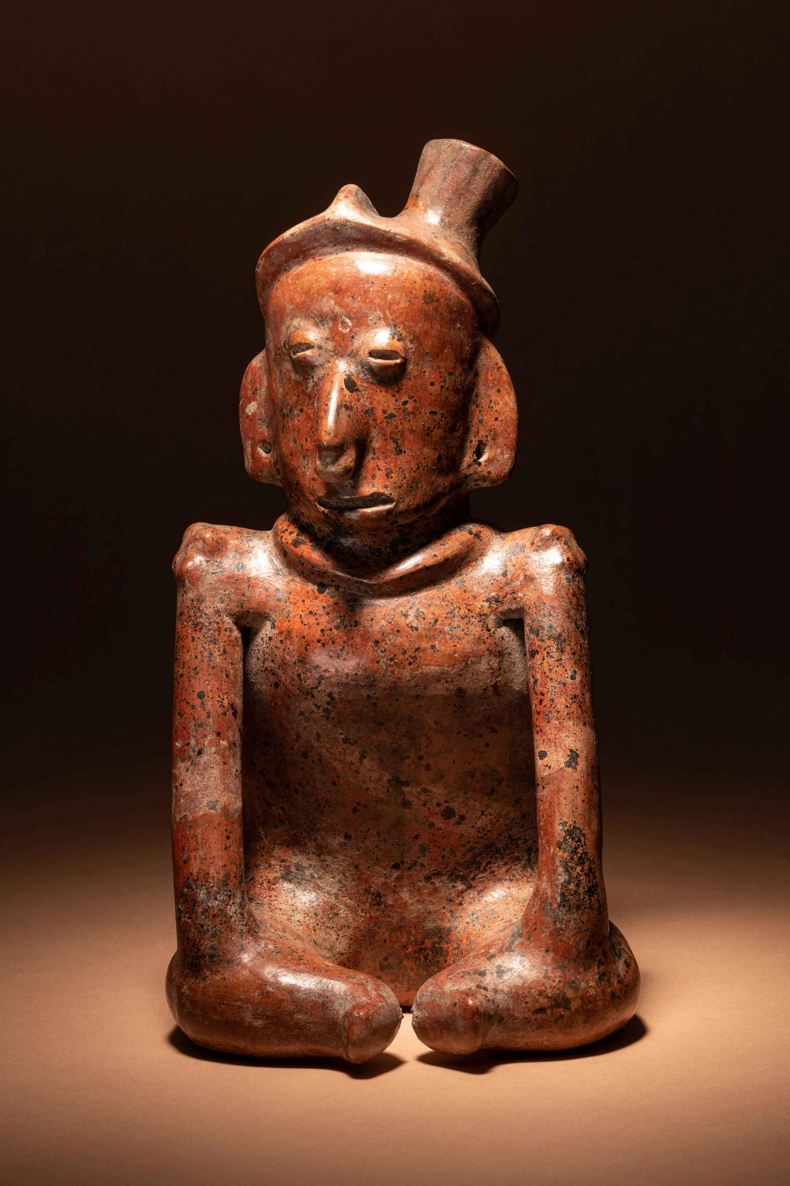 A Colima Terracotta Seated Figure Height 10 inches. (1 of 3)