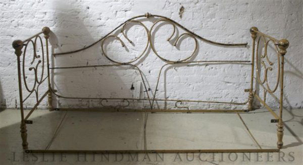 An Iron Folding Daybed, Height 32 inches.: An Iron Folding Daybed, having ball finial corners and scrolling decoration supported by turned legs. Height 32 inches.