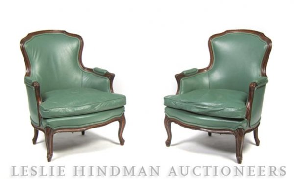 A Pair of Louis XVI Style Bergeres,: A Pair of Louis XVI Style Bergeres, having an upholstered back, arms and seat set within a carved frame raised on cabriole legs.