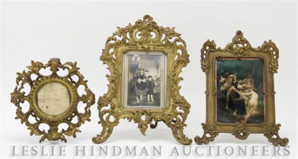 A Group of Three Gilt Metal Picture Frames, Height: A Group of Three Gilt Metal Picture Frames, having foliate form borders. Height of tallest 12 inches. Property from the Estate of Ernest Trova, St. Louis, Missouri