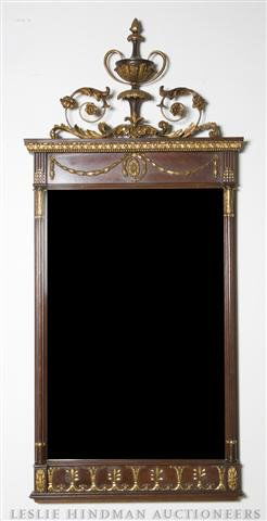 A Neoclassical Style Mahogany Mirror, Height 53 x: A Neoclassical Style Mahogany Mirror, having urn form decoration at top, surmounting columns, and swagged and gilt decoration. Height 53 x 24 inches. Property from the Estate of Ernest Trova, St. Loui