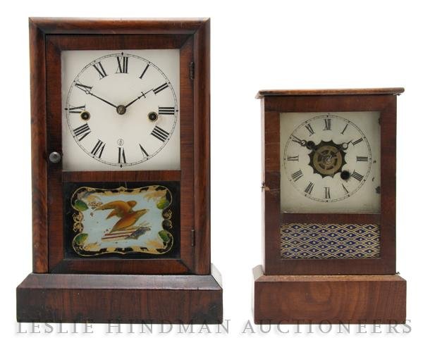 An American Mahogany Mantle Clock, Height of first: An American Mahogany Mantle Clock, the dial with Roman numerals over an eglomise panel of an eagle and an American flag together with a smaller example with panel of diamond and star pattern. Height o
