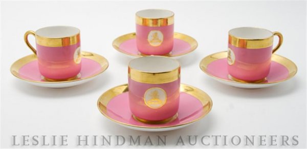 A Set of Eight English Demitasse Cups and Saucers,: A Set of Eight English Demitasse Cups and Saucers, Minton, having pink reserve with thick gilt borders at rims, each piece containing a circular medallion with a gilt lion at center with banner readin