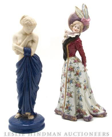 A Royal Worcester Porcelain Figure, Height of firs: A Royal Worcester Porcelain Figure, depicting a classicaly drapped maiden, together with another porcelain figure depicting a lady in 19th century garb. Height of first 10 7/8 inches.