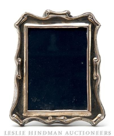 An English Silver Picture Frame, Height 7 1/2 inch: An English Silver Picture Frame, having scrolling motif. Height 7 1/2 inches. Property from the Grace Hokin Estate, Chicago, Illinois