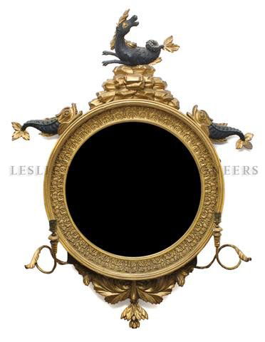 A Giltwood Convex Mirror, Height overall 46 inches: A Giltwood Convex Mirror, the circular plate surmounted with dolphins and a hippocampus issuing two scrolling candle arms. Height overall 46 inches.