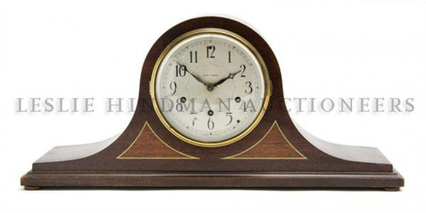 An American Mahogany Mantle Clock, Seth Thomas, He: An American Mahogany Mantle Clock, Seth Thomas, of domed form, the circular dial with Arabic numerals, having time and strike movement. Height 9 1/4 inches.