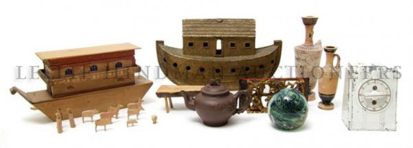 A Collection of Decorative Objects, Length of long: A Collection of Decorative Objects, comprising two models of the ark, one in metal and one in wood, two pottery vessels after the antique, a glass paperweight and others. Length of longest 12 inches.