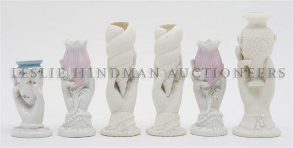 A Collection of Six Vases, Height of tallest 7 3/4 inch: A Collection of Six Vases, each depicting a hand holding an element, including shells, an urn, tulips and a vase. Height of tallest 7 3/4 inches.