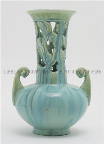 An American Fulper Pottery Vase, Height 11 inches.: An American Fulper Pottery Vase, having a green glaze, of baluster form with pierce carved foliate decoration and two decorative handles, the base incised Fulper, further marked 4060. Height 11 inches
