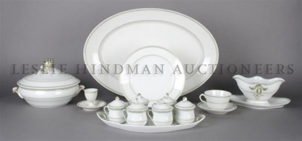 A Partial Set of French Dinnerware, Pillivuyt, Width of: A Partial Set of French Dinnerware, Pillivuyt, comprising three trays, two covered serving bowls, a center bowl, plates, cups, saucers and various serving articles. Width of largest tray 20 inches. Ha