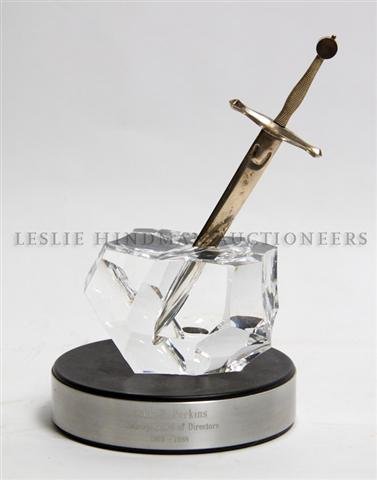 A Steuben Glass, Sterling Silver and 18 Karat Gold 'Exc: A Steuben Glass, Sterling Silver and 18 Karat Gold 'Excalibur' Paperweight and Letter Opener Set, designed by James Houston in 1963. Length of sword 8 inches. Property from the Estate of Mrs. John H. 