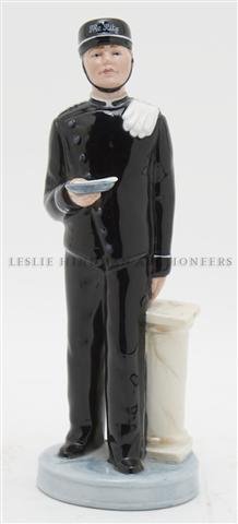 A Royal Doulton Figurine of a Bell Boy, Height 7 7/8 in: A Royal Doulton Figurine of a Bell Boy, depicted before a column holding a tray with a letter raised on a circular base, HN 2772, signed and dated "Factory Standard, Eric Griffiths." Height 7 7/8 inch