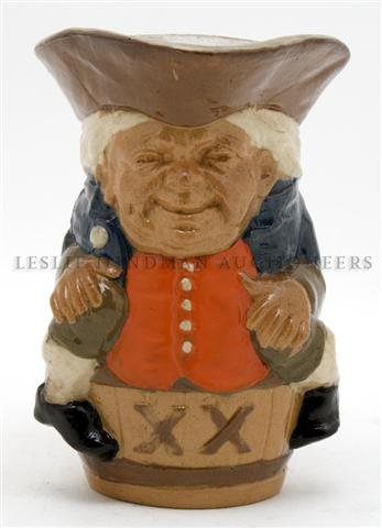 A Royal Doulton Lambeth Stoneware Toby, Height 5 1/2 in: A Royal Doulton Lambeth Stoneware Toby, the figure seated on a barrel marked 'XX' having a salt glaze, designed by Harry Simeon. Height 5 1/2 inches.