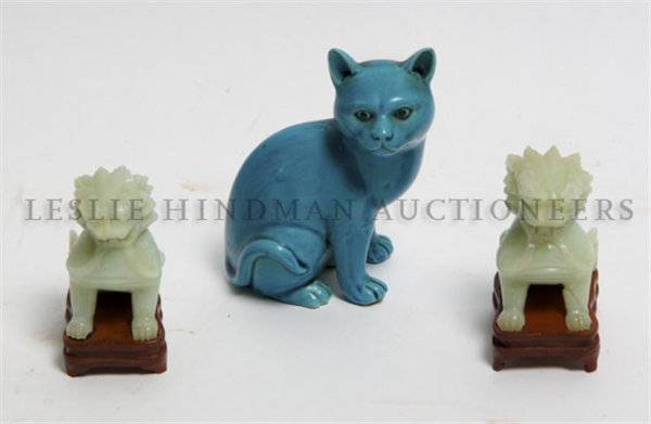 A Pair of Carved Hardstone Foo Dogs, Height of first 3 : A Pair of Carved Hardstone Foo Dogs, each raised on a fitted base, together with a monochrome figure of a cat. Height of first 3 1/8 inches. Property from the Estate of Mrs. John H. (Len W.) Perkins, 