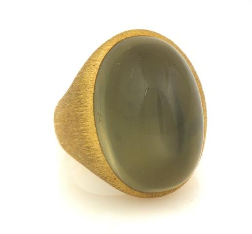 An 18 Karat Yellow Gold and Moonstone Ring, Henry Dunay: An 18 Karat Yellow Gold and Moonstone Ring, Henry Dunay, containing one oval cabochon cut moonstone weighing approximately 31.25 carats. Stamp: DUNAY 18K #03754. 11.60 dwts. Property From the Estate o