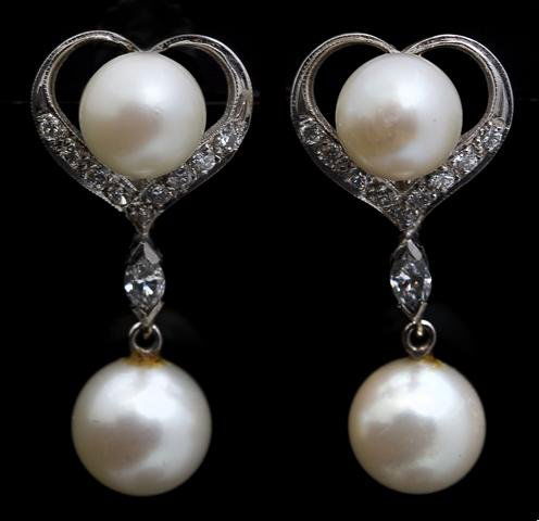 A Pair of 14 Karat White Gold, Cultured Pearl and Diamo: A Pair of 14 Karat White Gold, Cultured Pearl and Diamond Screwback Earrings, containing four cultured pearls measuring approximately 7.50 - 8.50 mm in diameter, 22 round brilliant cut diamonds weighi