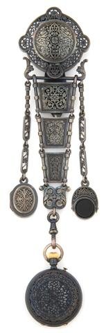 A Victorian Silver Chatelaine, Otterbourg & Cie, circa : A Victorian Silver Chatelaine, Otterbourg & Cie, circa 1880, consisting of a filigree locket intended for hair ornament, a hinged pendant set with onyx and agate, and a filigree pocket watch with whit