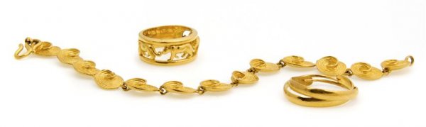 A Group of 24 Karat Yellow Gold Jewelry, 30.50 dwts.: A Group of 24 Karat Yellow Gold Jewelry, consisting of a textured link bracelet, a pair of hoop earrings and an open filigree band depicting felines. Stamp: 999.9. 30.50 dwts. Property of Julie Heidt,