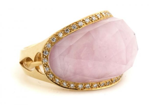 An 18 Karat Yellow Gold, Rock Crystal and Diamond Jelly: An 18 Karat Yellow Gold, Rock Crystal and Diamond "Jellybean" Ring, Stephen Webster, containing one saddle cut checkerboard top rock crystal quartz measuring approximately 22.60 x 12.30 mm with pink b