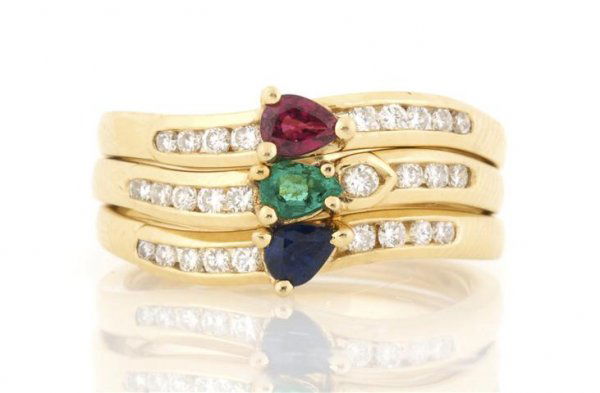 An 18 Karat Yellow Gold and Multi Color Stacked" Ring, : An 18 Karat Yellow Gold and Multi Color "Stacked" Ring, containing pear shape sapphire, emerald and ruby, 27 round brilliant cut diamonds weighing approximately 0.35 carat total. 5.00 dwts. Property F
